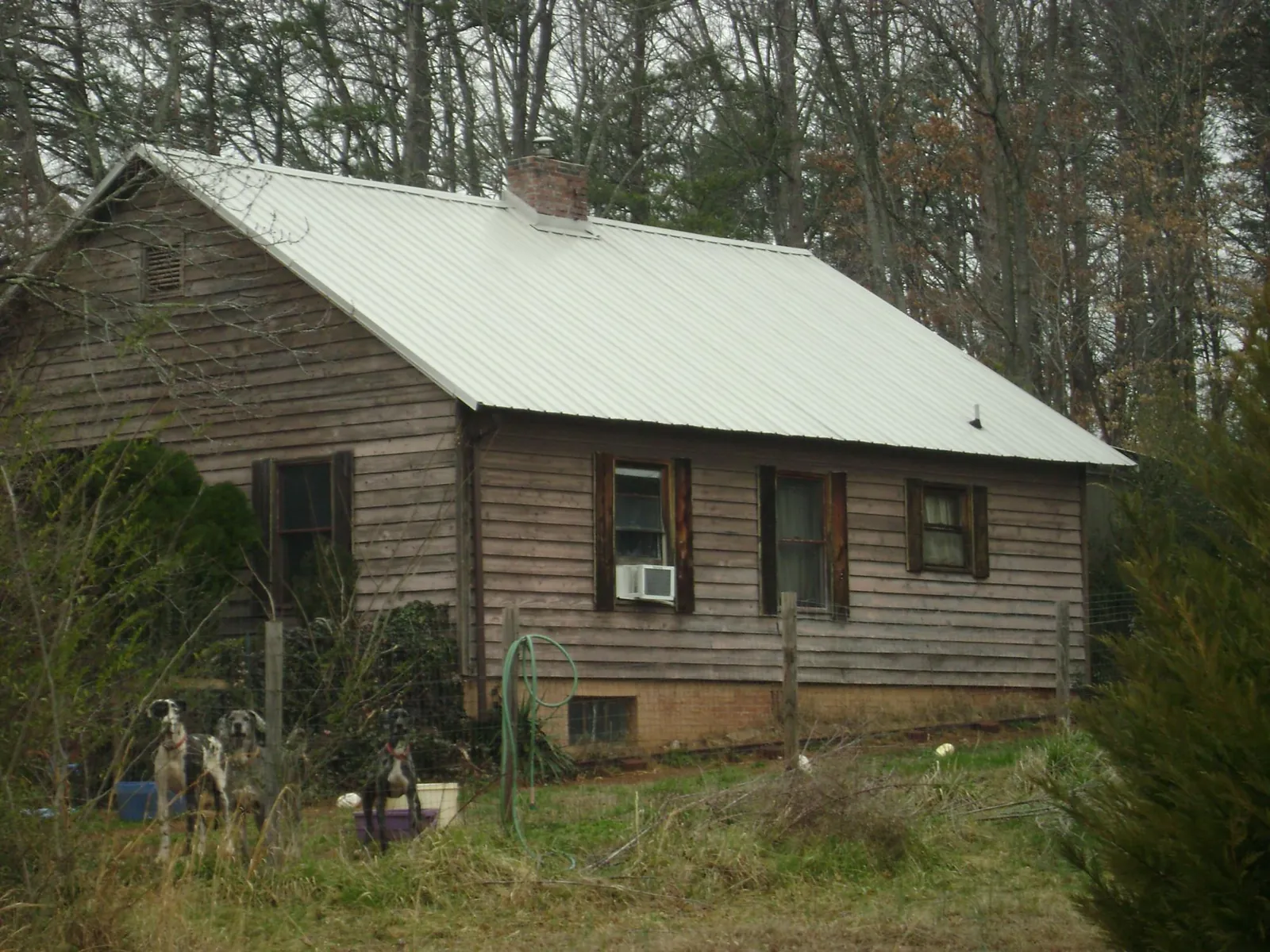 White metal roof on an old wood sided farmhouse in Waco